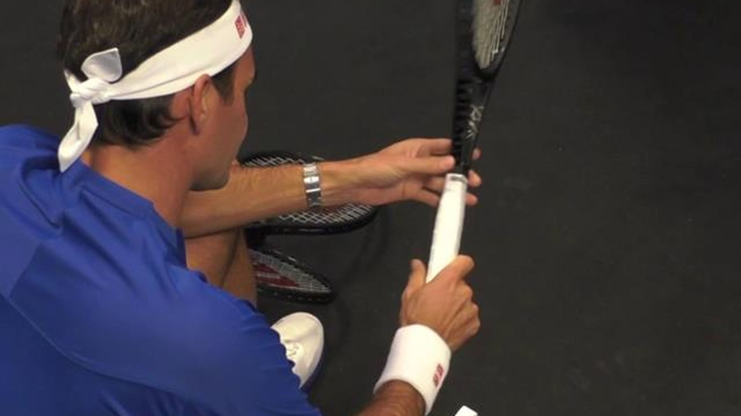 Roger Federer re-grips his racquet backstage ahead of the final match ...