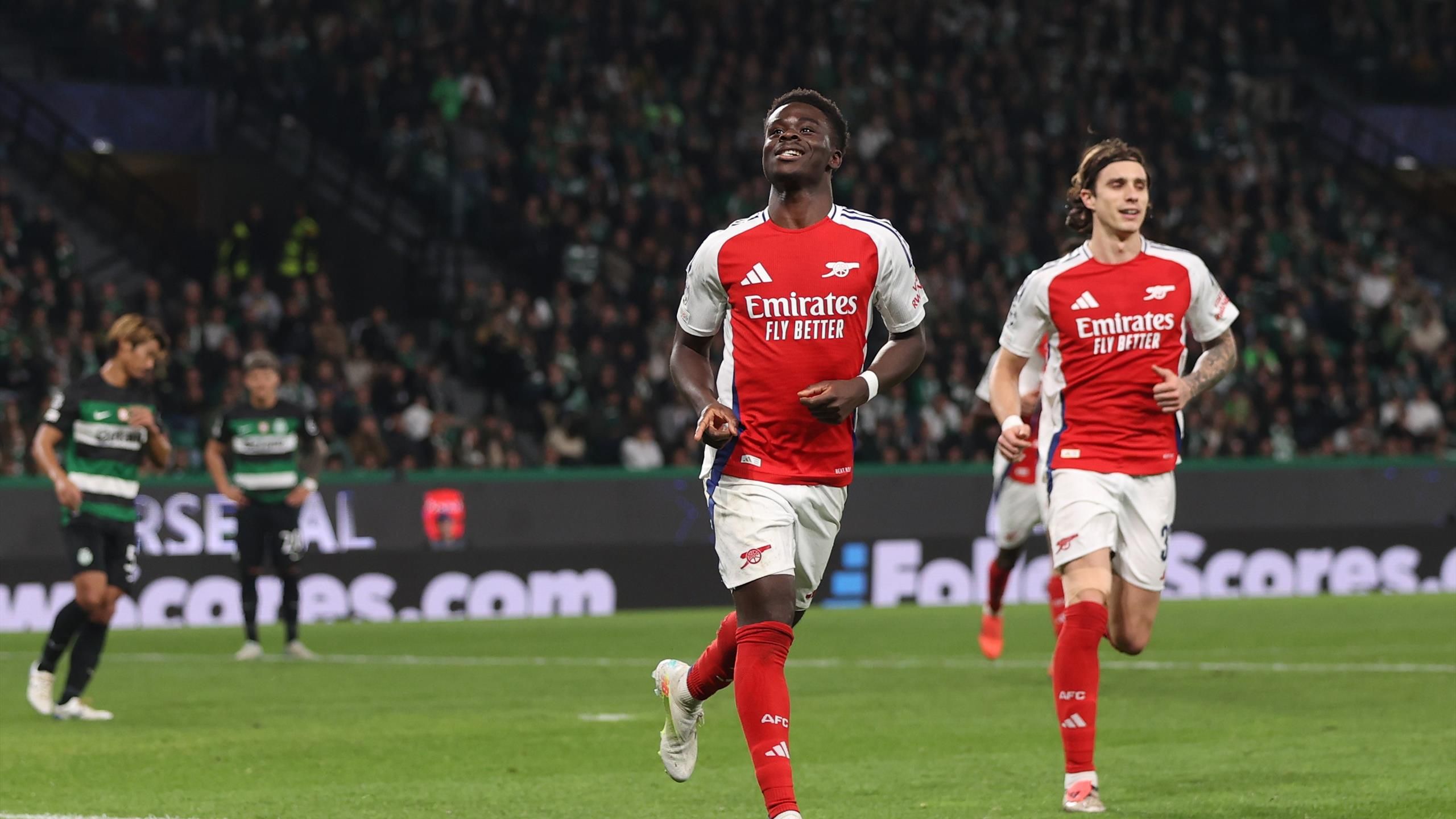 Arsenal players celebrating a goal during the UEFA Champions League match against Sporting Lisbon.